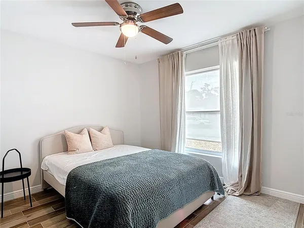 a bedroom with a bed and a window