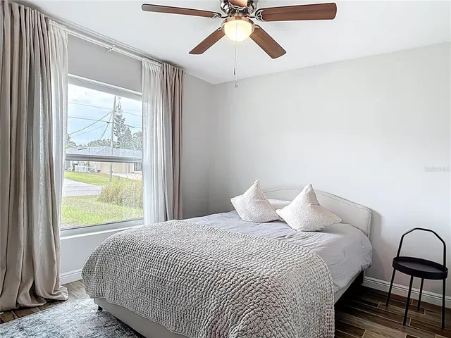 a bedroom with a bed and a window