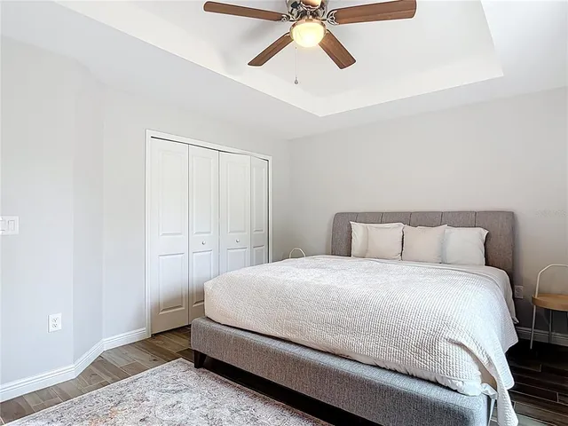 a view of a house with a yard and potted plants