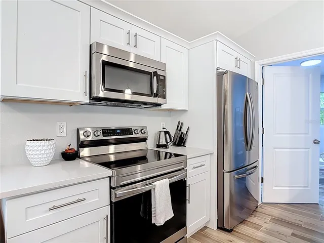 a kitchen with stainless steel appliances granite countertop a refrigerator stove and microwave