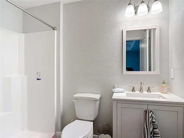 a aerial view of a house with table and chairs under an umbrella