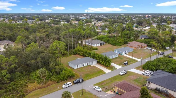 an aerial view of a house with yard swimming pool and outdoor seating
