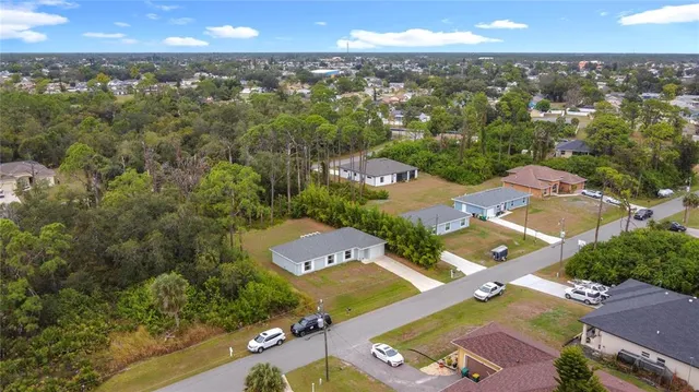 an aerial view of a house with yard swimming pool and outdoor seating