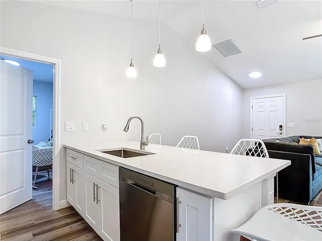 a kitchen with a sink a stove and cabinets