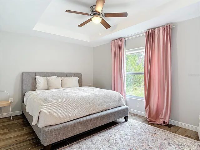 a view of a dining room with furniture a chandelier and wooden floor