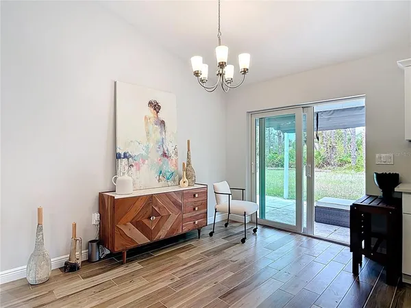 a kitchen with stainless steel appliances a stove a sink cabinets and wooden floor