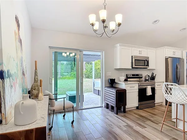 a kitchen that has a lot of cabinets a sink and appliances in it
