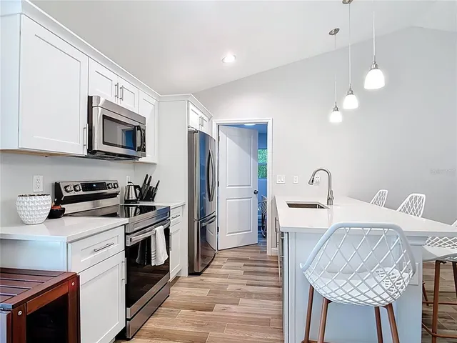 a bedroom with a bed and a chandelier fan