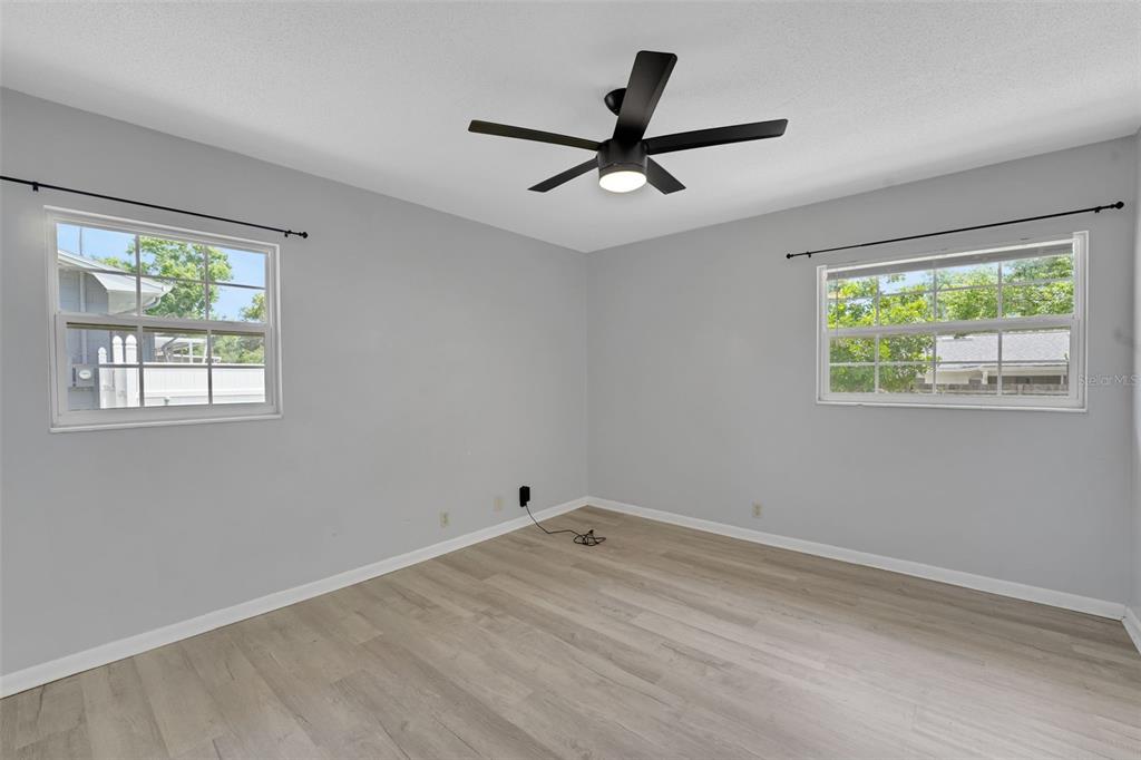 404 Lake Ned Road Winter Haven, FL 33884 - Photo 13 of 18 a view of a big room with wooden floor closet and windows