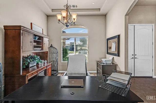 a living room with furniture a rug and a bookshelf