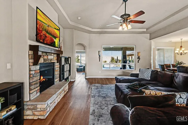 a living room with furniture a ceiling fan and a rug