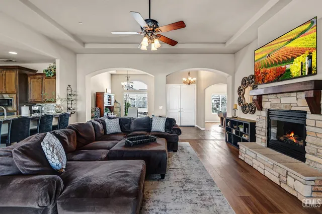 a living room with furniture a fireplace and a flat screen tv