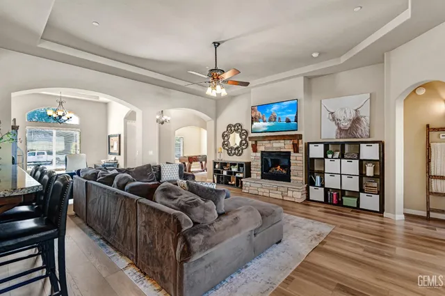a dining room filled chandelier and wooden floor