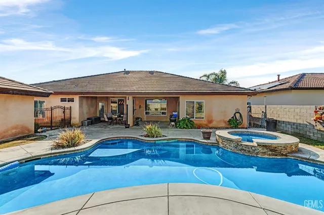a view of a house with swimming pool and sitting area