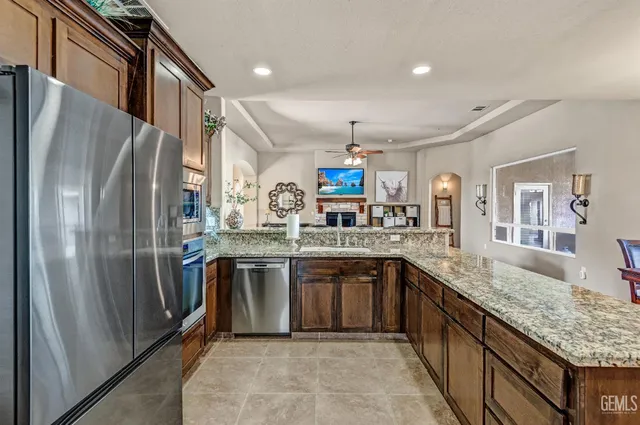 a kitchen with stainless steel appliances granite countertop a sink and cabinets