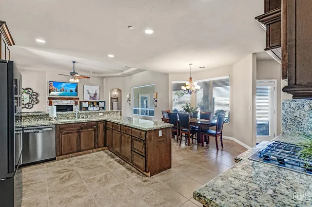 a living room with lots of furniture and a book shelf