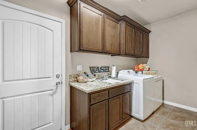 a bathroom with a granite countertop sink a toilet a mirror and shower
