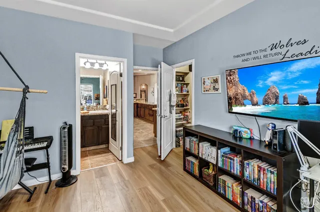 a bedroom with a bed and wooden floor