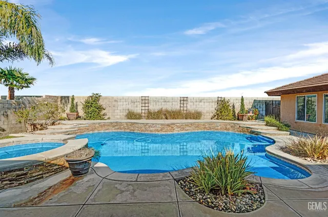 a kitchen with granite countertop a sink stove top oven and cabinets