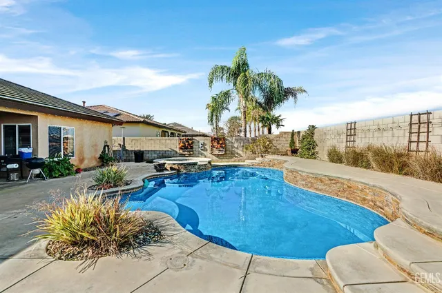 a living room with furniture and a view of kitchen