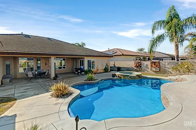 a kitchen with stainless steel appliances granite countertop a stove a sink a microwave and a refrigerator