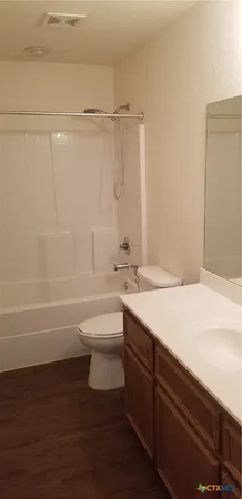 a bathroom with a sink a toilet and a bathtub