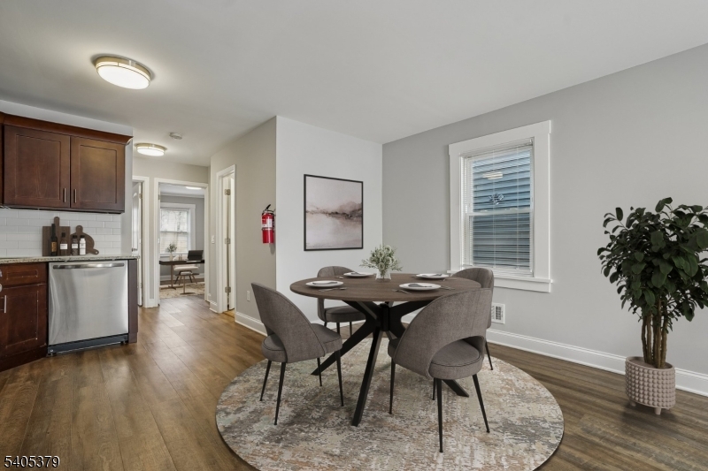 a view of a dining room with furniture and wooden floor