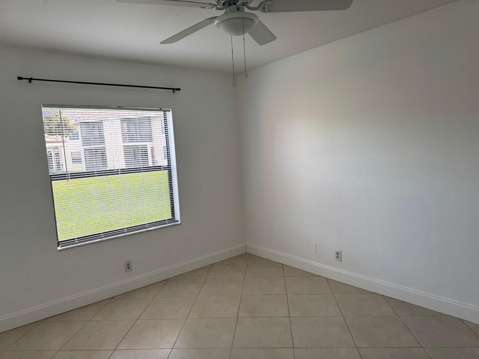6772 Palmetto Circle South, Unit 104 Boca Raton, FL 33433 - Photo 11 of 17 an empty room with a window