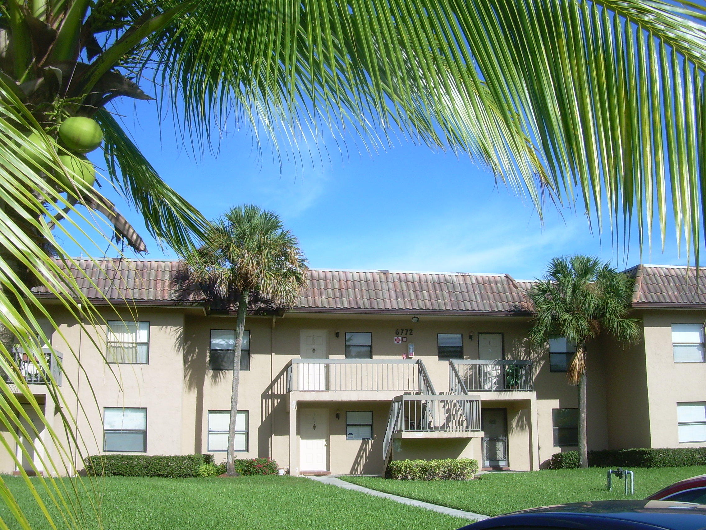 6772 Palmetto Circle South, Unit 104 Boca Raton, FL 33433 - Photo 13 of 17 a front view of a house with swimming pool
