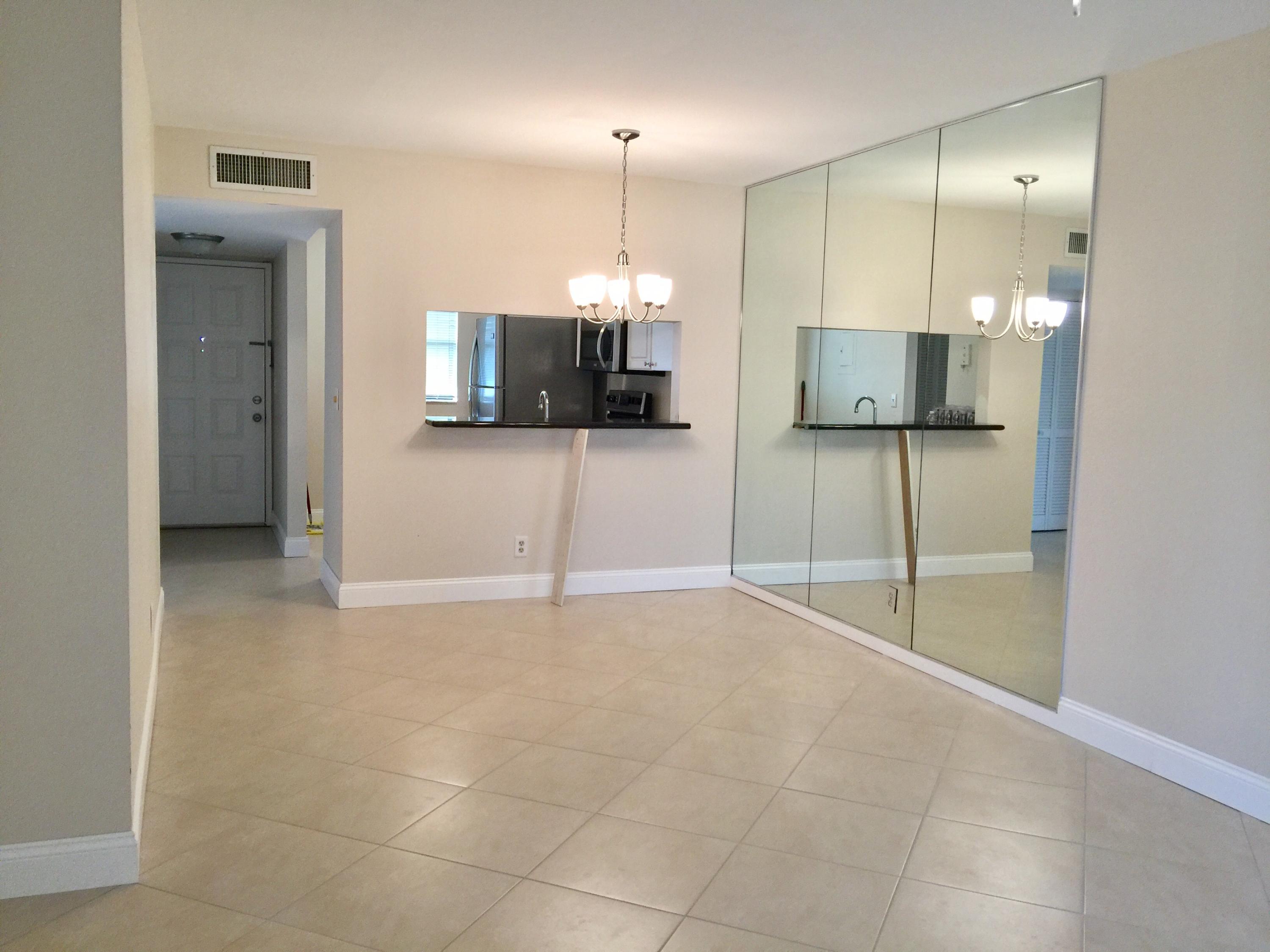 6772 Palmetto Circle South, Unit 104 Boca Raton, FL 33433 - Photo 6 of 17 a view of a livingroom with a flat screen tv and outdoor view