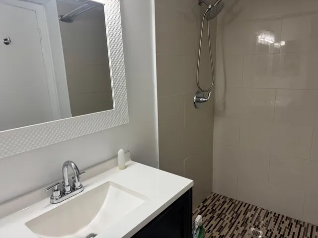 a bathroom with a sink vanity and a mirror