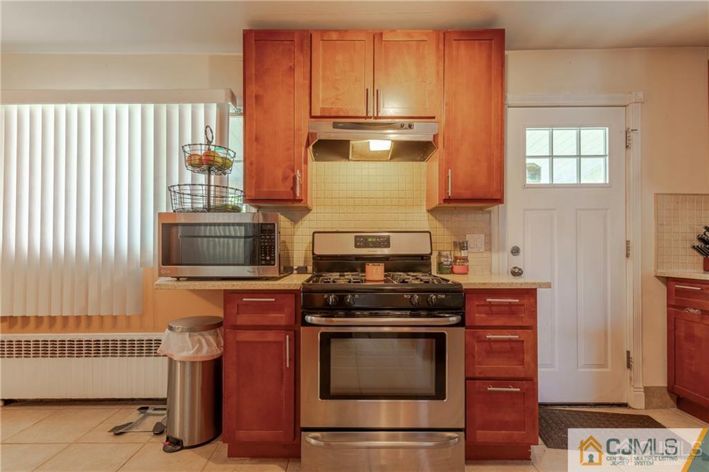 297 Washington Road Sayreville, NJ 08872 - Photo 17 of 44 a kitchen with a stove and a microwave
