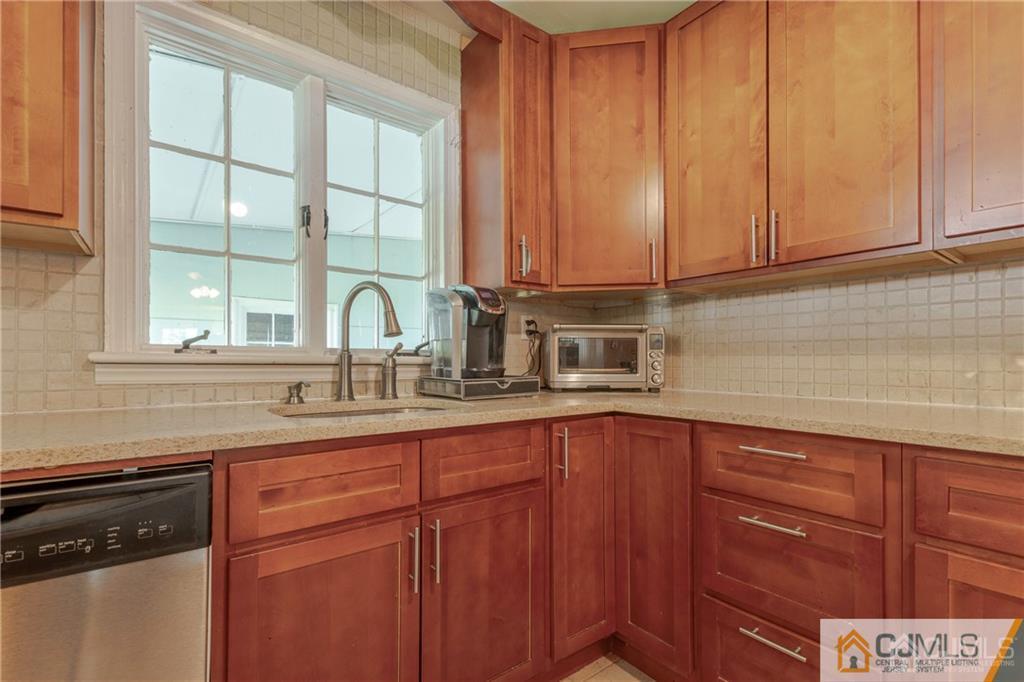 297 Washington Road Sayreville, NJ 08872 - Photo 18 of 44 a kitchen with stainless steel appliances granite countertop a sink and cabinets