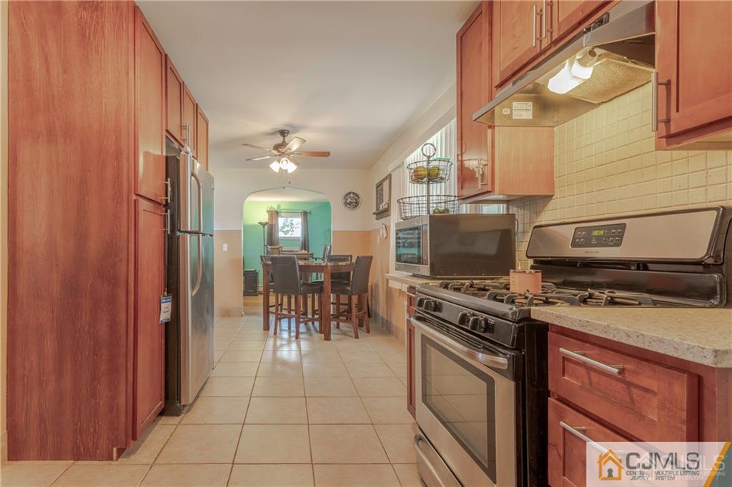 297 Washington Road Sayreville, NJ 08872 - Photo 19 of 44 a kitchen with a stove top oven cabinets and a table