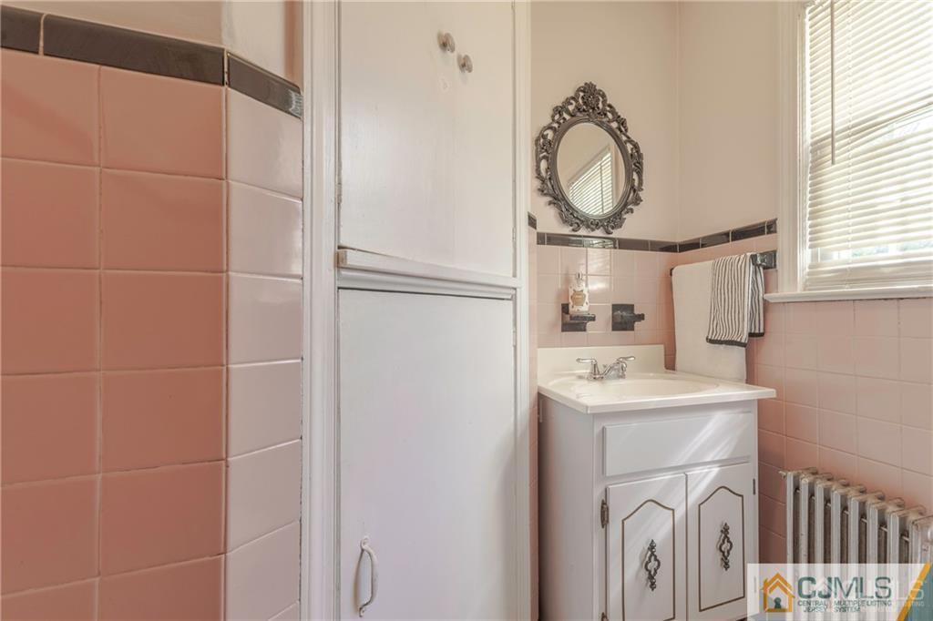 297 Washington Road Sayreville, NJ 08872 - Photo 20 of 44 a bathroom with a sink a toilet and a mirror