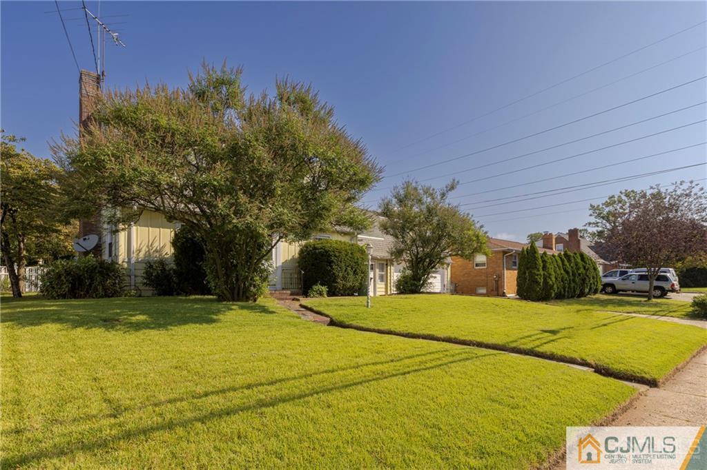 297 Washington Road Sayreville, NJ 08872 - Photo 3 of 44 a view of swimming pool with outdoor seating and trees