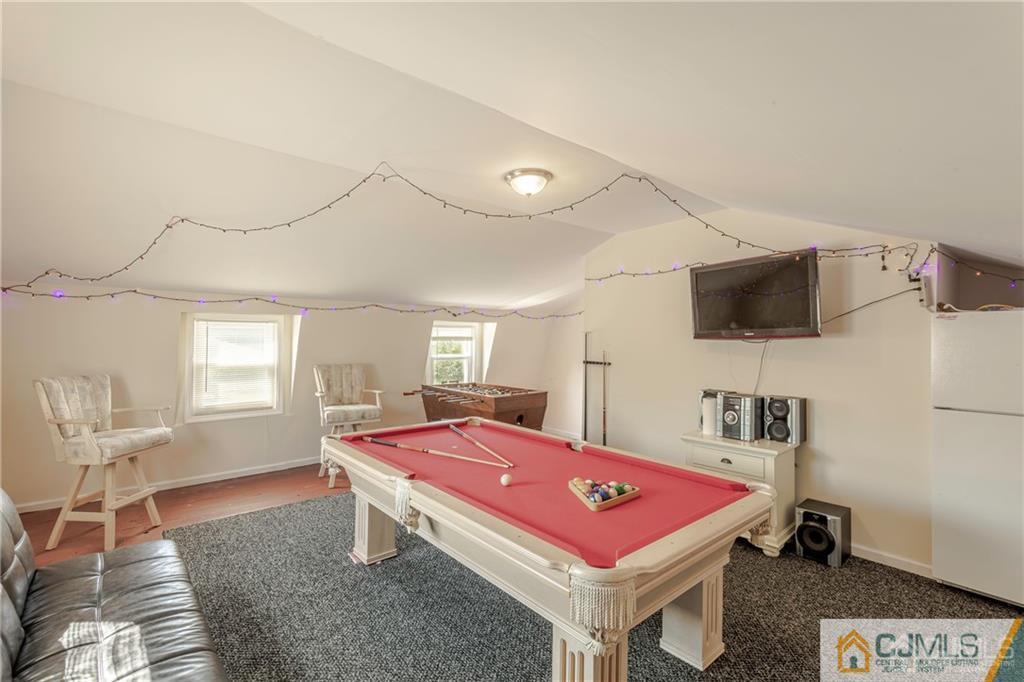 297 Washington Road Sayreville, NJ 08872 - Photo 34 of 44 a room with gym equipment and a flat screen tv