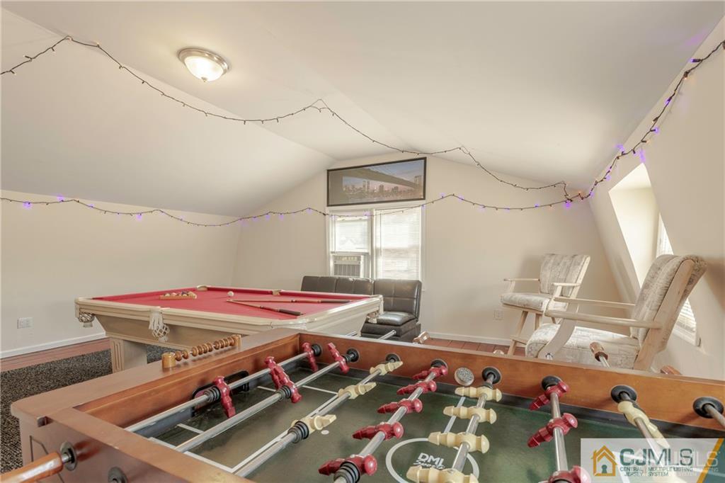 297 Washington Road Sayreville, NJ 08872 - Photo 36 of 44 a bedroom with a bed and a chandelier