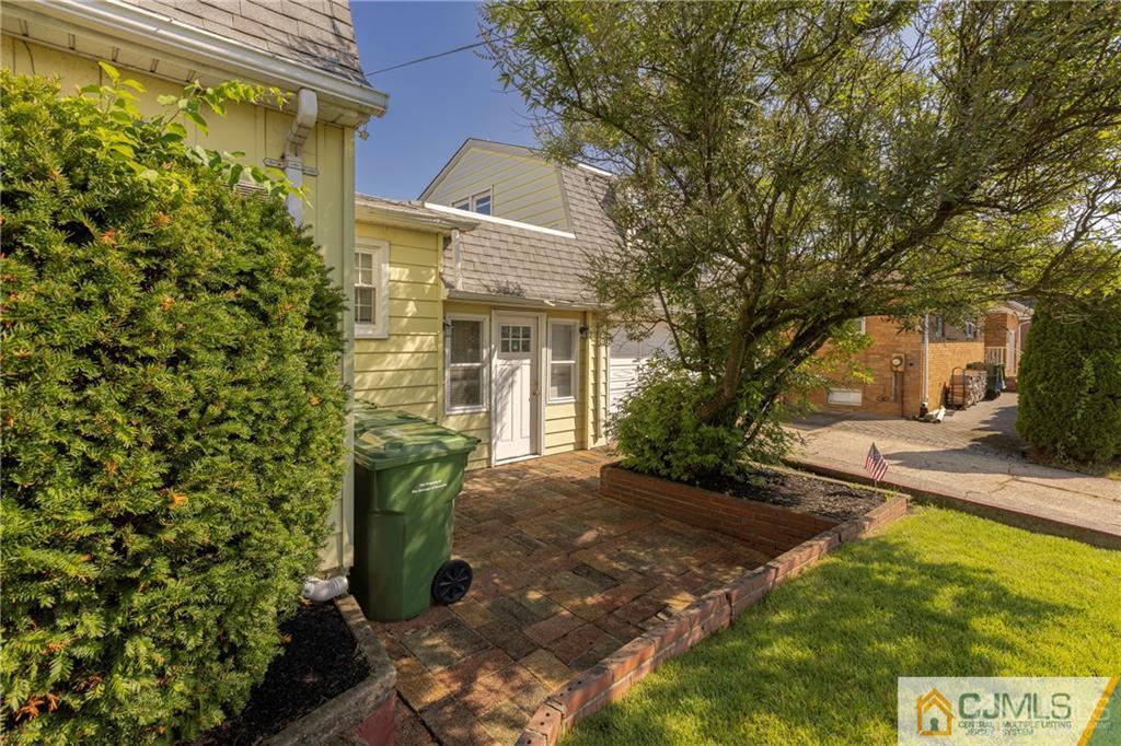 297 Washington Road Sayreville, NJ 08872 - Photo 5 of 44 a view of a yard with plants and a fountain