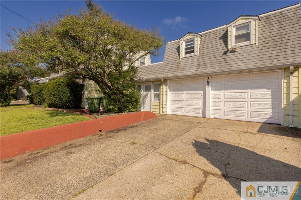 297 Washington Road Sayreville, NJ 08872 - Photo 6 of 44 a front view of a house with a yard and garage