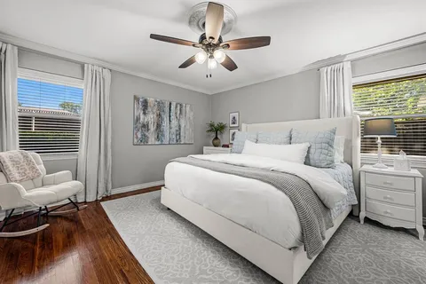 a bedroom with a bed couch and a window