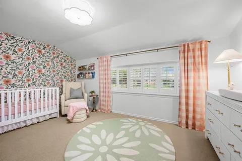 a bed room with a bed and a chair