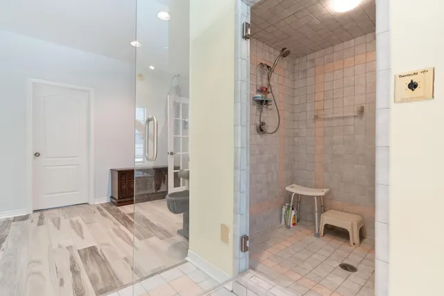 a dining room filled a chandelier and kitchen view