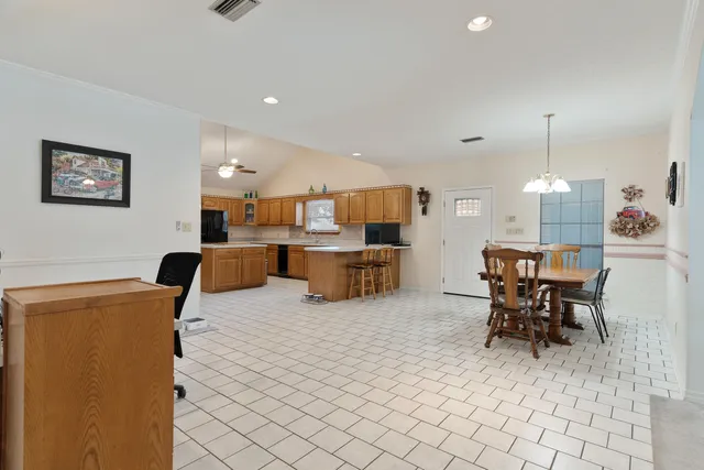 a room with pool table and windows