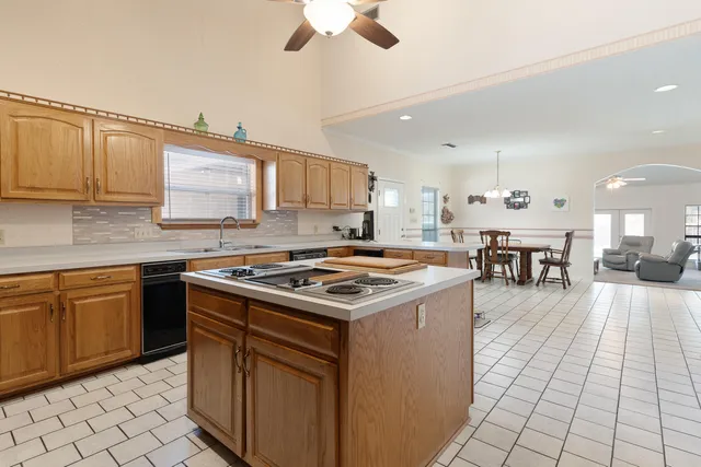a front view of house with yard and trees in the background