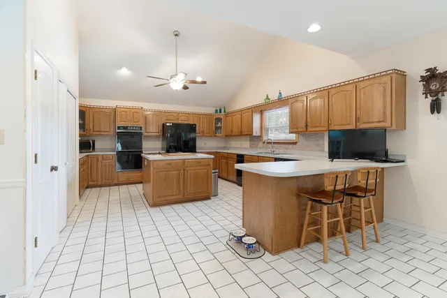 a view of a room with wooden floor a rug and a window