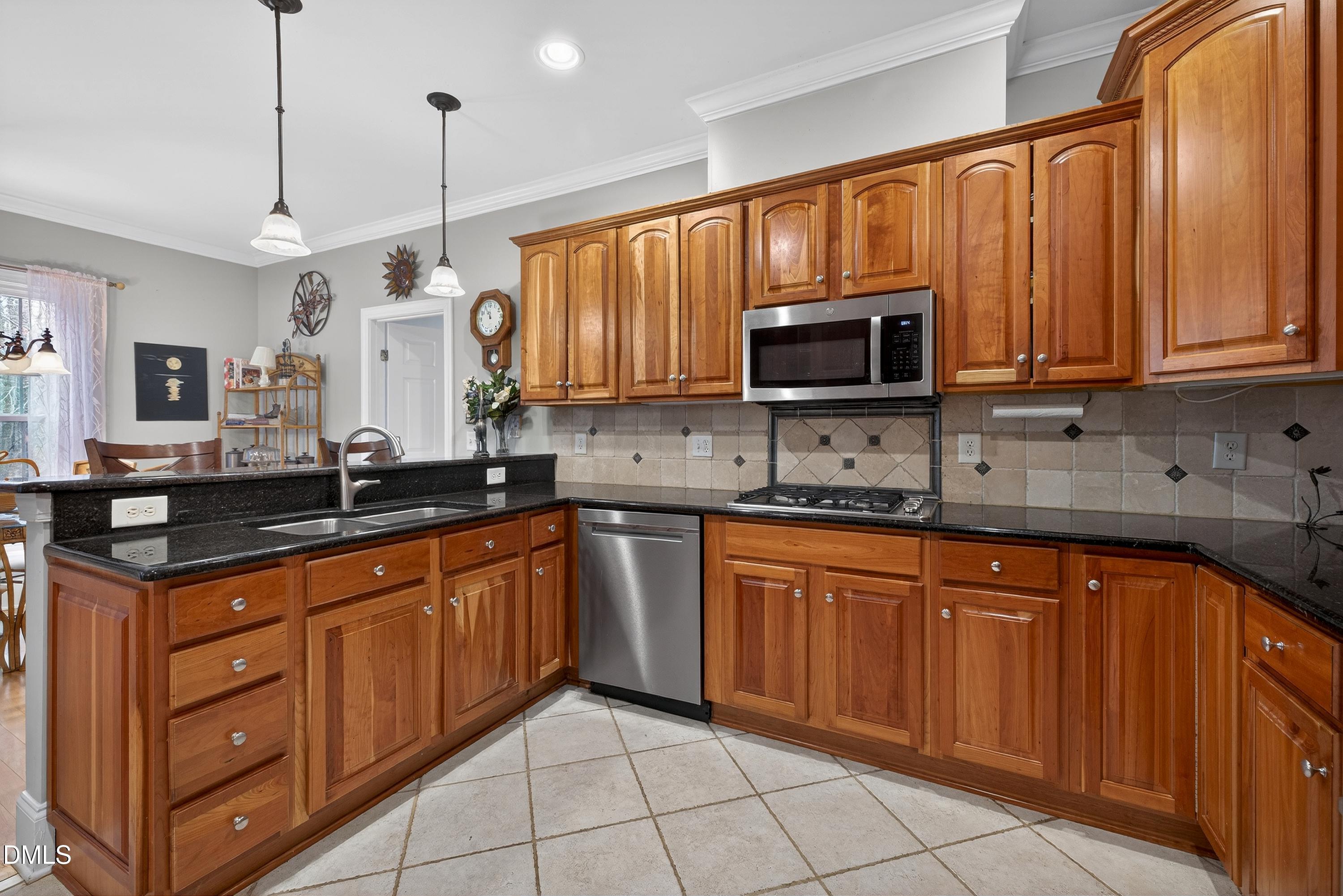4613 Cross Brook Lane Raleigh, NC 27610 - Photo 15 of 53 a kitchen with granite countertop a sink stainless steel appliances and cabinets