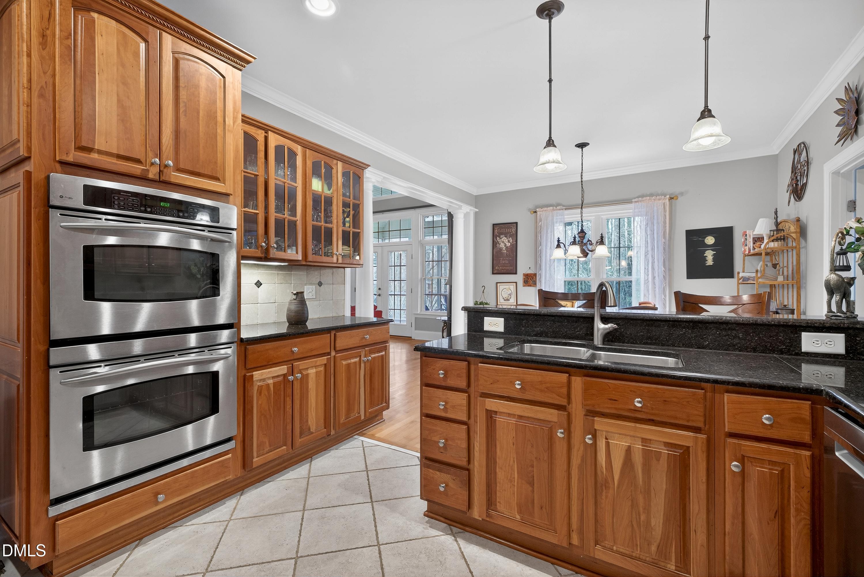 4613 Cross Brook Lane Raleigh, NC 27610 - Photo 16 of 53 a kitchen with granite countertop cabinets stainless steel appliances and a sink