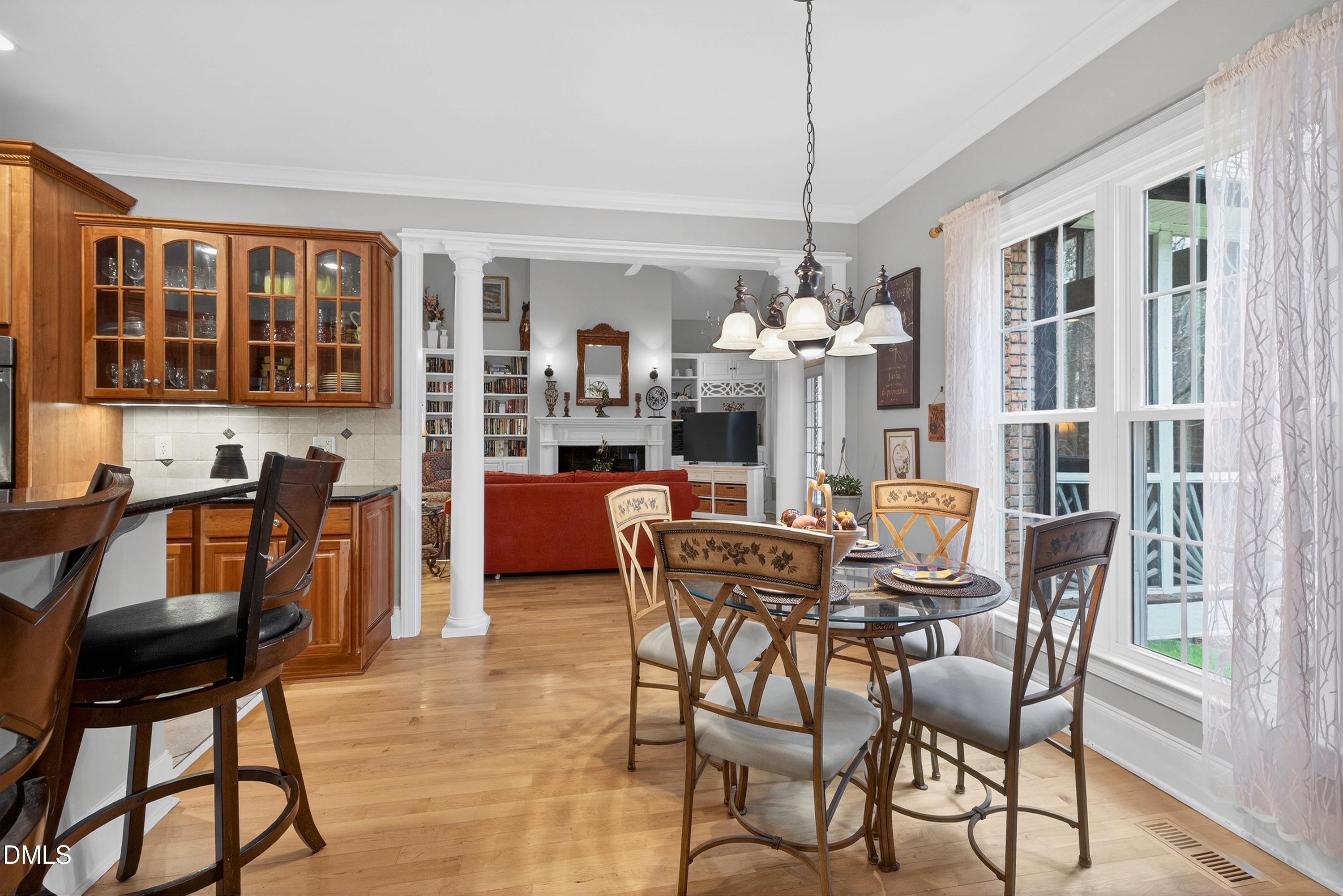 4613 Cross Brook Lane Raleigh, NC 27610 - Photo 18 of 53 a dining room with furniture a chandelier and wooden floor