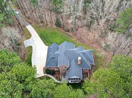 an aerial view of a house with a garden and a trees